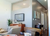 Thumbnail 25 of 36 - Living and dining area with mid century modern furnishings at 68 Beale Apartments, Massachusetts, 02169